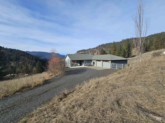 view of front of property featuring a garage and a mountain view