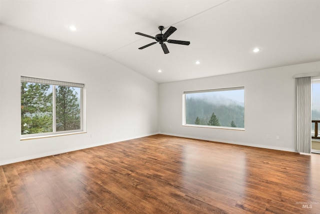 unfurnished room with hardwood / wood-style flooring, ceiling fan, and vaulted ceiling