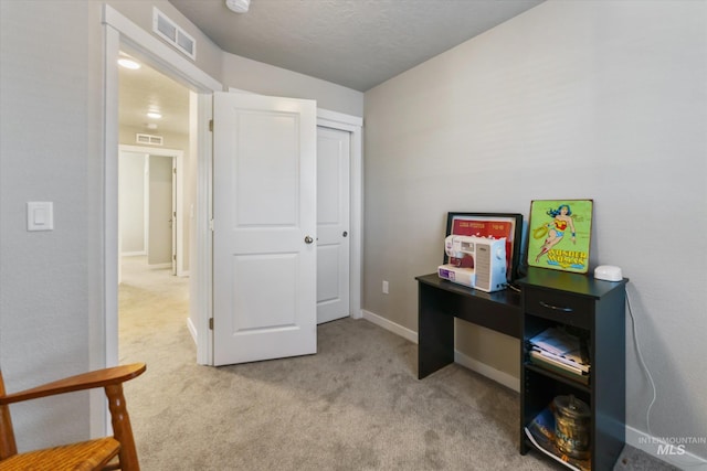 interior space with light colored carpet and a textured ceiling