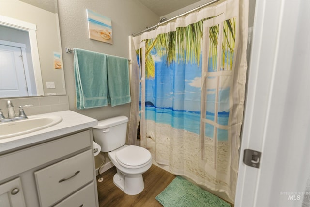 bathroom with hardwood / wood-style floors, vanity, toilet, a textured ceiling, and a shower with shower curtain