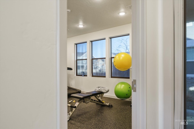 workout room featuring a textured ceiling