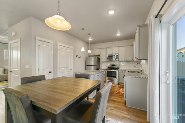 dining area featuring sink and light hardwood / wood-style flooring