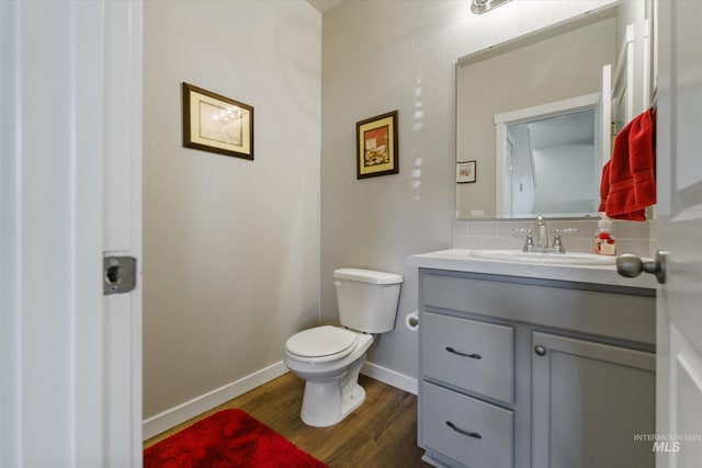 bathroom with vanity, wood-type flooring, and toilet