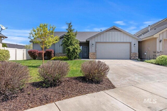 single story home featuring board and batten siding, stone siding, an attached garage, and driveway