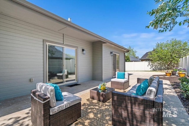 view of patio / terrace featuring outdoor lounge area and fence