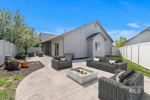 rear view of property featuring an outdoor living space with a fire pit, a patio area, and a fenced backyard