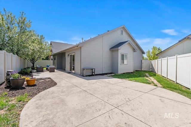 back of house featuring a patio and a fenced backyard