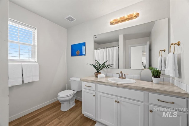 655 N Sevenoaks Ave, Eagle, ID 83616 - bathroom featuring vanity, wood finished floors, toilet, and baseboards