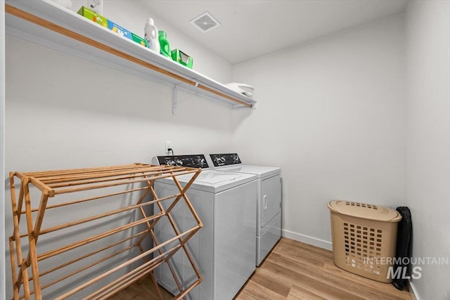 655 N Sevenoaks Ave, Eagle, ID 83616 - laundry area featuring washer and dryer, light wood-type flooring, and baseboards