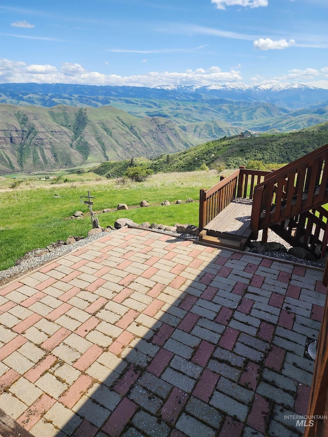 view of patio featuring a deck with mountain view