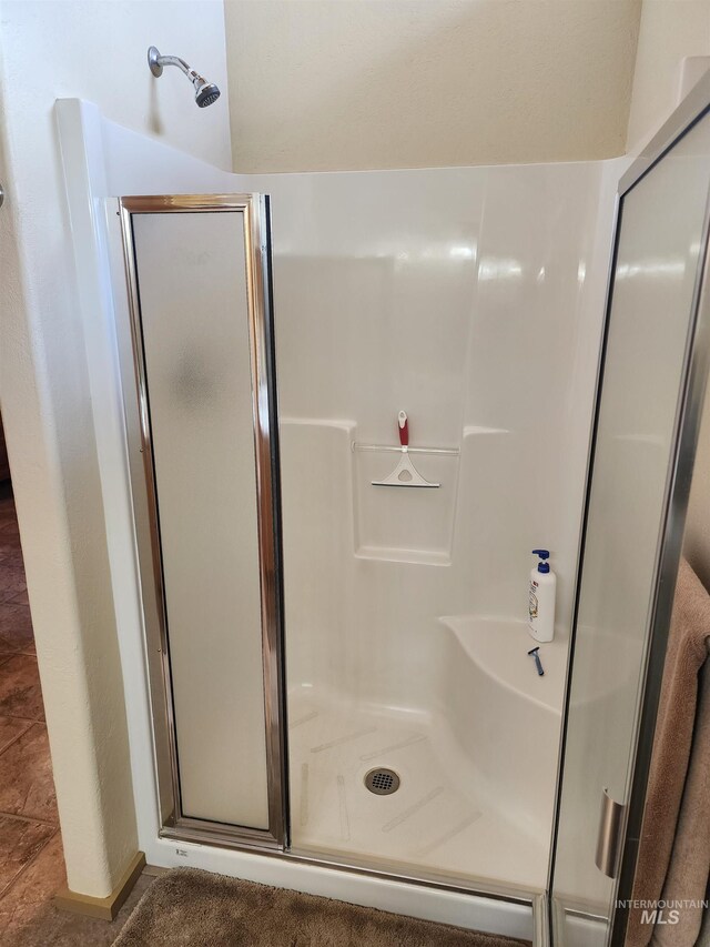 full bathroom featuring a stall shower