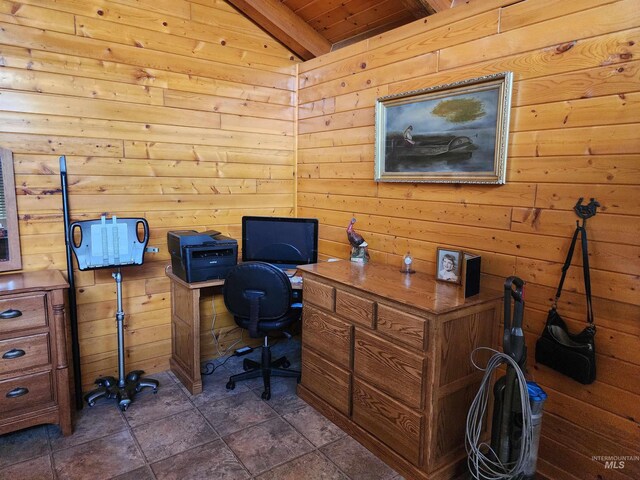 office featuring vaulted ceiling with beams, wood walls, stone finish flooring, and wooden ceiling