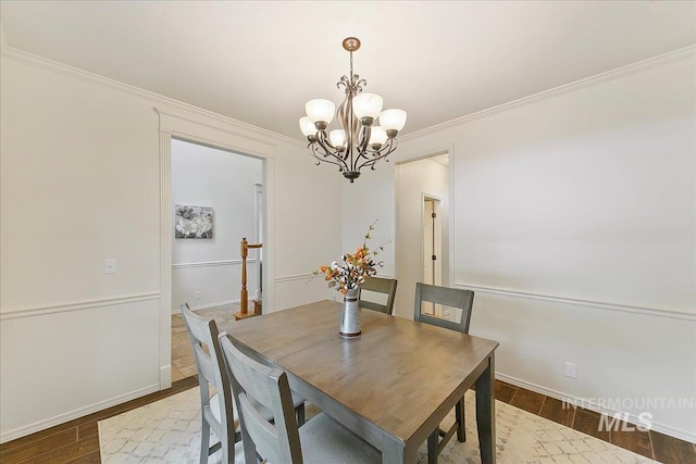 9874 W Whirlaway Ct, Boise, ID 83704 - dining space featuring a chandelier, crown molding, dark wood-style floors, and baseboards