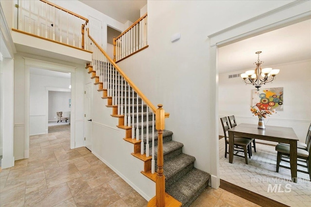 9874 W Whirlaway Ct, Boise, ID 83704 - staircase featuring stone finish floors, a chandelier, and baseboards