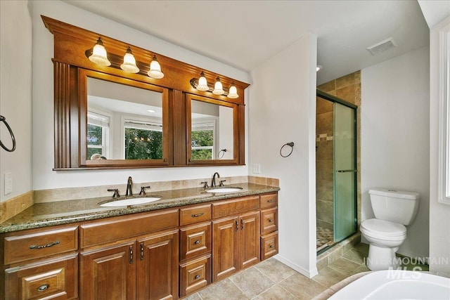 9874 W Whirlaway Ct, Boise, ID 83704 - full bath featuring double vanity, a stall shower, tile patterned floors, and toilet