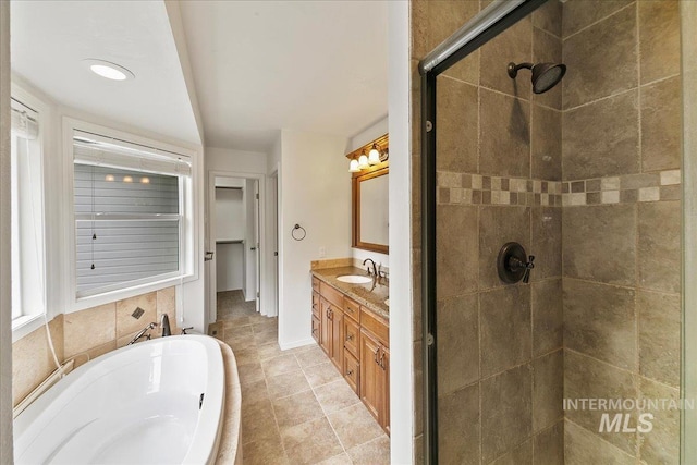 9874 W Whirlaway Ct, Boise, ID 83704 - full bathroom featuring a shower stall, a bath, vanity, and baseboards
