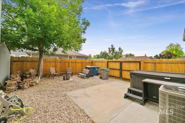 9874 W Whirlaway Ct, Boise, ID 83704 - fenced backyard with a hot tub, central AC, and a patio
