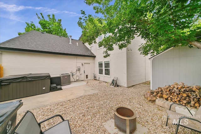 9874 W Whirlaway Ct, Boise, ID 83704 - rear view of house with a hot tub, a patio area, central air condition unit, and roof with shingles