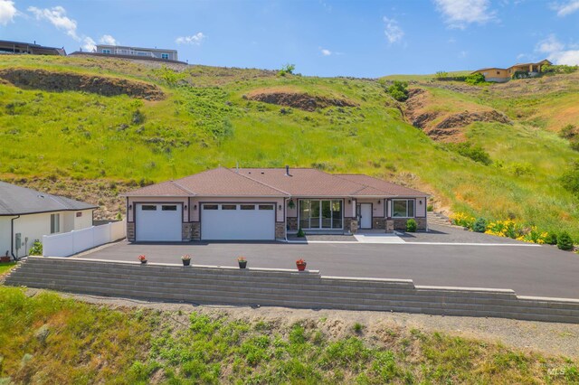 60 Appleford Ct, Asotin, WA 99402 - ranch-style house featuring an attached garage, stone siding, and driveway