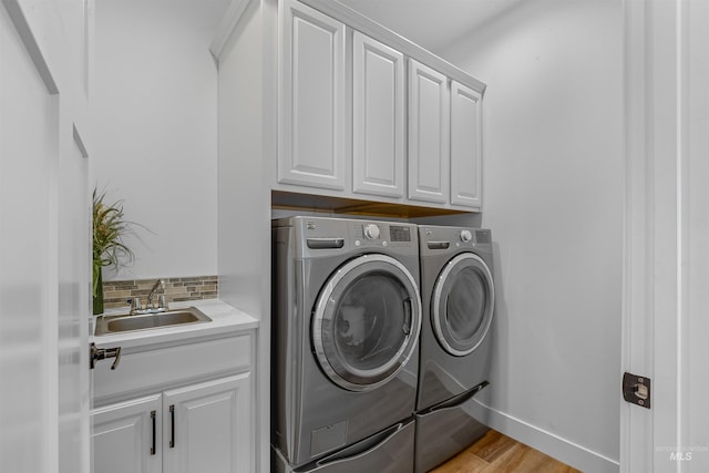 60 Appleford Ct, Asotin, WA 99402 - laundry area with separate washer and dryer, cabinet space, light wood-style flooring, and baseboards