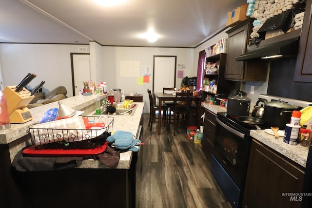 kitchen with black electric range oven, a sink, dark wood-style floors, and light countertops