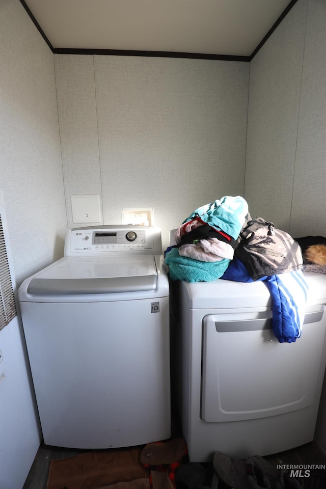 laundry area with a heating unit, washer and clothes dryer, and laundry area