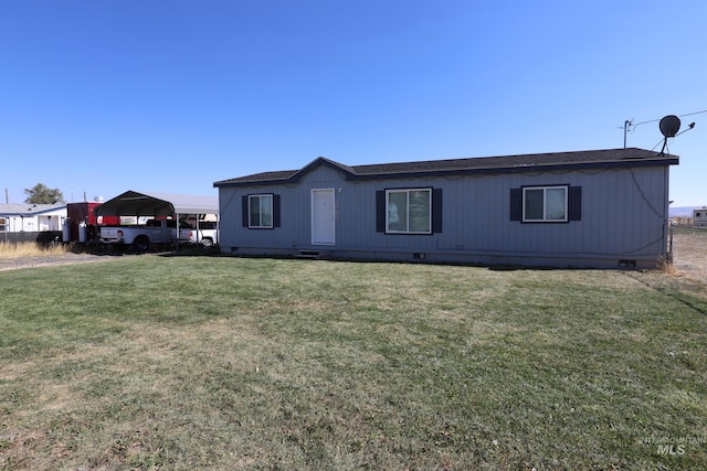 manufactured / mobile home with a carport, crawl space, a shingled roof, and a front lawn