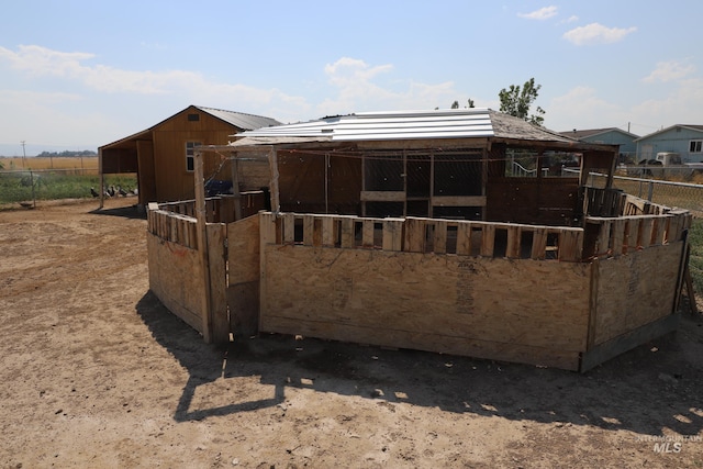 rear view of house featuring an outbuilding