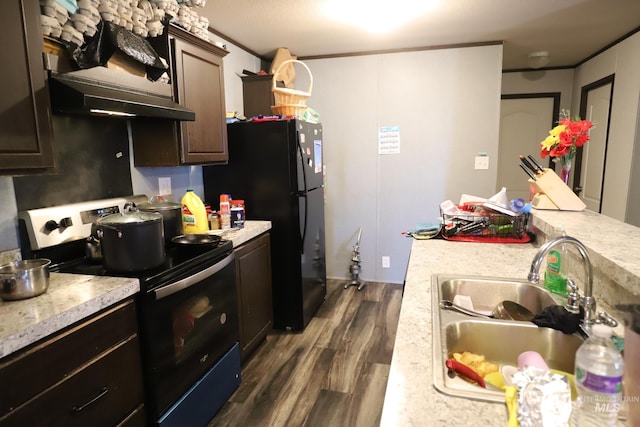kitchen with black appliances, under cabinet range hood, a sink, and light countertops