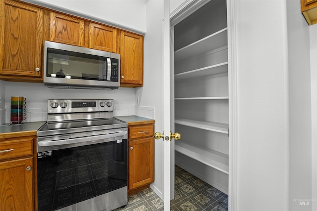 7842 Arlington Dr, Nampa, ID 83687 - kitchen with stainless steel appliances and brown cabinetry