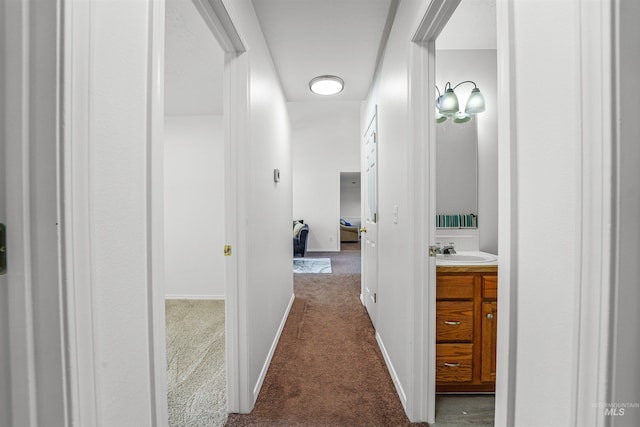 7842 Arlington Dr, Nampa, ID 83687 - corridor featuring dark carpet, a sink, and baseboards