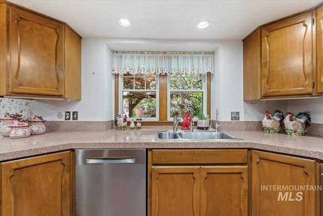 3428 N Columbine Ave, Boise, ID 83713 - kitchen with stainless steel dishwasher, a sink, brown cabinets, light countertops, and recessed lighting