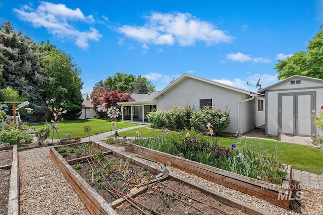 3428 N Columbine Ave, Boise, ID 83713 - back of house featuring a garden, a lawn, and stucco siding