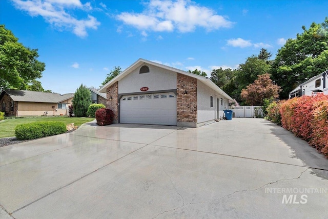 3428 N Columbine Ave, Boise, ID 83713 - view of front of house featuring concrete driveway, an attached garage, brick siding, and stucco siding
