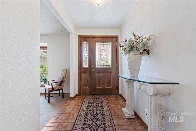3428 N Columbine Ave, Boise, ID 83713 - foyer featuring baseboards, a textured ceiling, and ornamental molding