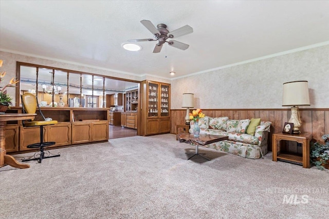3428 N Columbine Ave, Boise, ID 83713 - carpeted living area featuring a wainscoted wall, a ceiling fan, crown molding, wallpapered walls, and wood walls