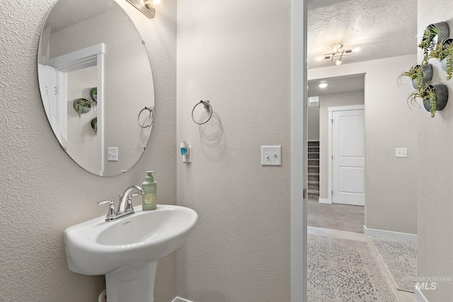 bathroom with sink and a textured ceiling