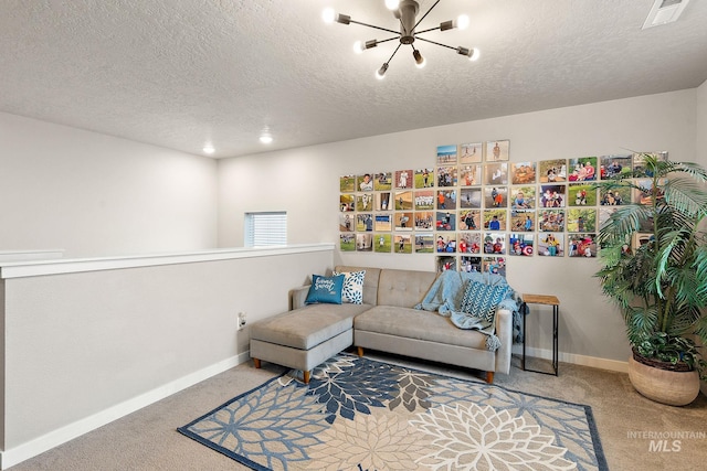 sitting room with carpet, a textured ceiling, and a chandelier