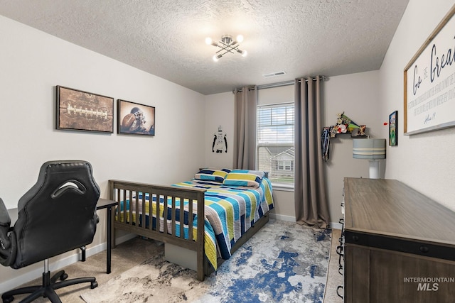 bedroom with light carpet, a chandelier, and a textured ceiling