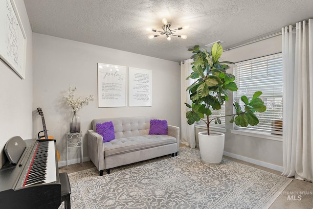 living room with a notable chandelier and a textured ceiling