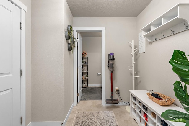 mudroom with a textured ceiling