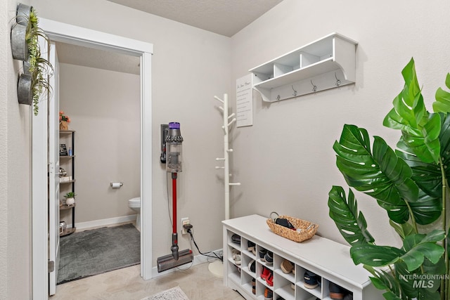 mudroom featuring a textured ceiling