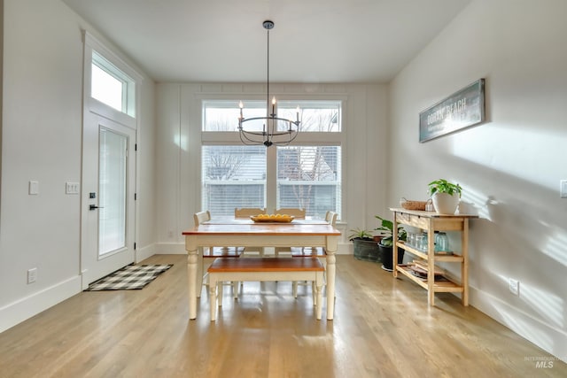 dining room featuring a notable chandelier and light wood-type flooring