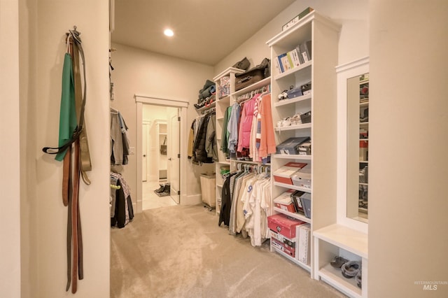 spacious closet featuring light colored carpet