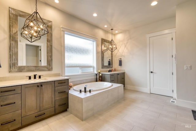 bathroom featuring tile patterned flooring, vanity, and a relaxing tiled tub