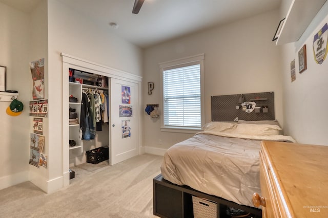 carpeted bedroom featuring a closet and ceiling fan