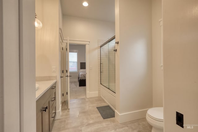 full bathroom featuring tile patterned floors, vanity, combined bath / shower with glass door, and toilet