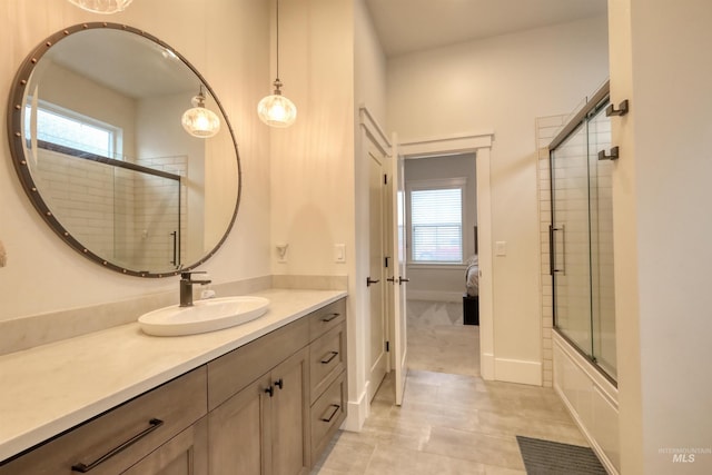 bathroom featuring tile patterned floors, vanity, and combined bath / shower with glass door