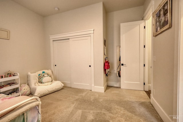 bedroom featuring a closet and light colored carpet