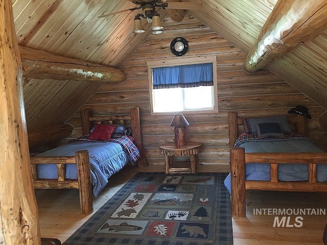 bedroom featuring hardwood / wood-style flooring, wood ceiling, log walls, and vaulted ceiling with beams